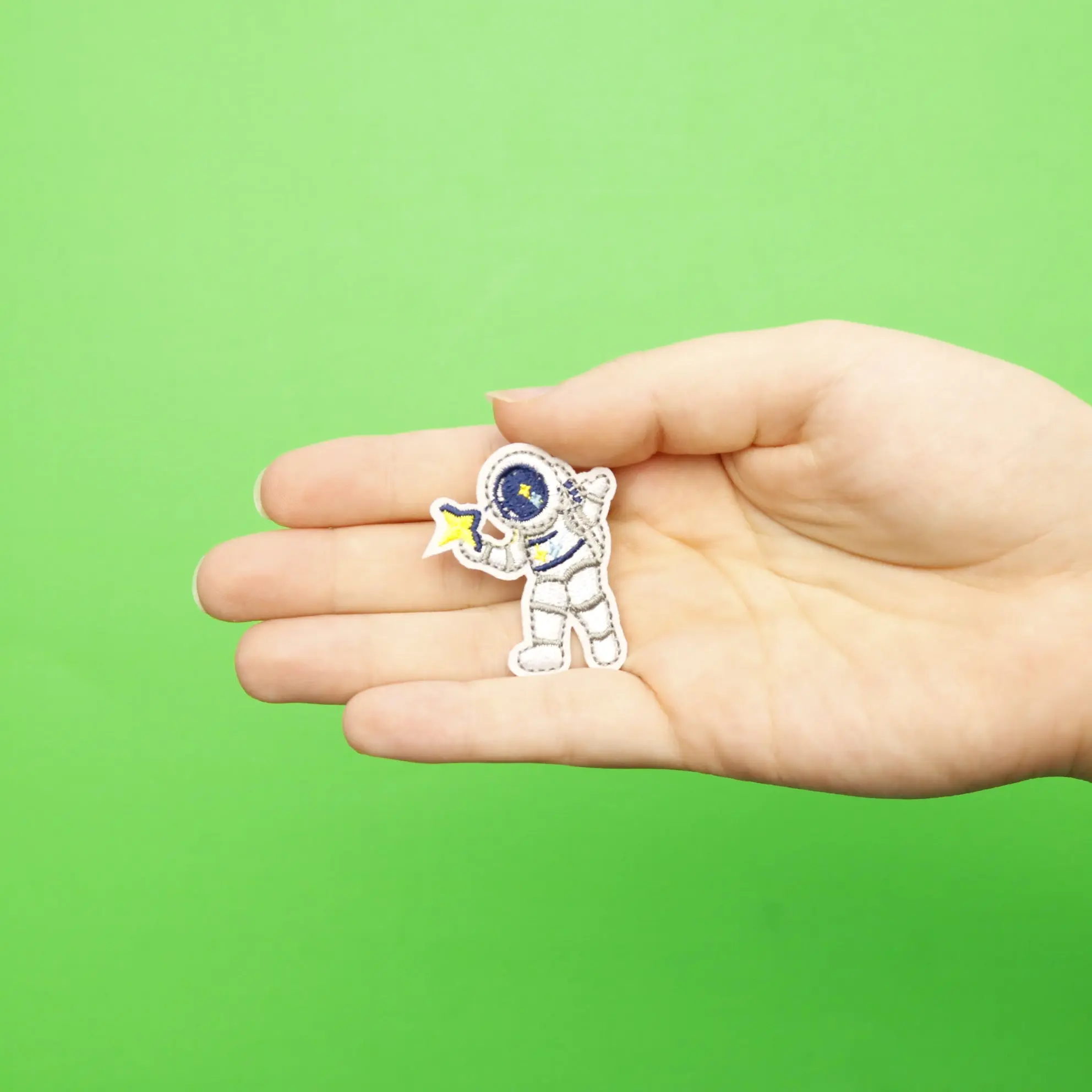Small Grey Astronaut Holding A Star Embroidered Iron On Patch - Image 2