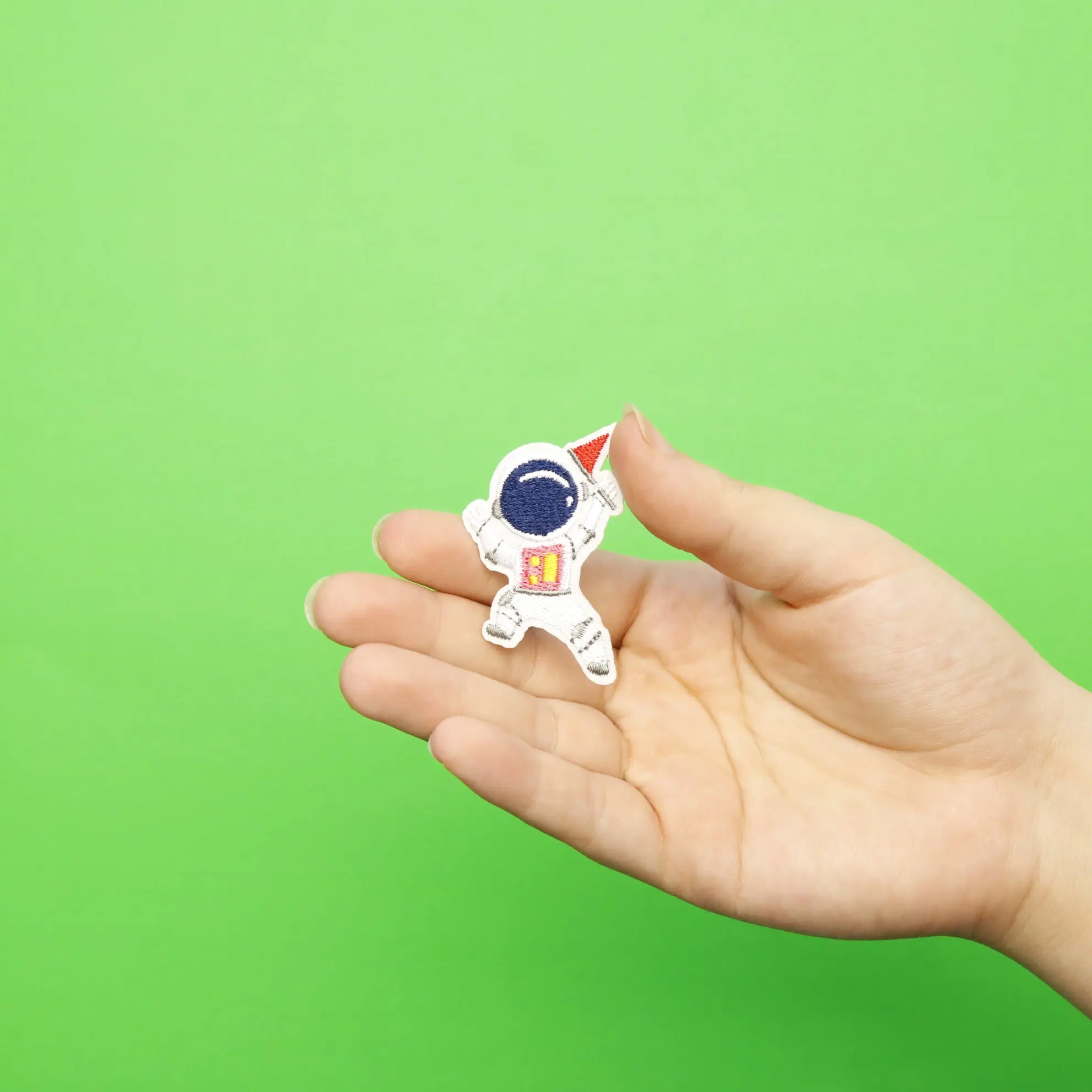 Small Pink Astronaut Holding A Small Red Flag Embroidered Iron On Patch - Image 2